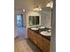 Double vanity bathroom with granite countertops and tile floors at 17346 Nature Walk Trail # 105, Parker, CO 80134