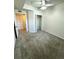 A carpeted bedroom with ceiling fan and closet at 17346 Nature Walk Trail # 105, Parker, CO 80134
