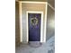 Purple front door with wreath, located in a condo building at 17346 Nature Walk Trail # 105, Parker, CO 80134
