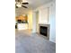 Living room with fireplace, carpet, and kitchen views at 17346 Nature Walk Trail # 105, Parker, CO 80134