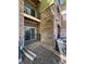 Private patio with stone flooring and a metal railing at 17346 Nature Walk Trail # 105, Parker, CO 80134
