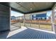 Back porch with wooden rails showing fenced backyard and view of other homes at 20936 E 61St Ave, Aurora, CO 80019