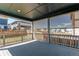 This back porch features a wooden floor, metal railing, and retractable privacy screen at 20936 E 61St Ave, Aurora, CO 80019