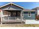 Covered back porch and patio featuring exterior views of the home at 20936 E 61St Ave, Aurora, CO 80019