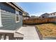 Yard view showcasing a concrete patio and the back of the house with its blue siding at 20936 E 61St Ave, Aurora, CO 80019