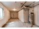 Unfinished basement view showing insulation, utilities, and some natural light from a window at 20936 E 61St Ave, Aurora, CO 80019