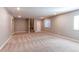 Large finished basement area featuring neutral paint, plush carpet and stairs to the upper level at 20936 E 61St Ave, Aurora, CO 80019