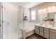 Modern bathroom with a glass-enclosed shower, soaking tub, and double vanity sinks at 20936 E 61St Ave, Aurora, CO 80019