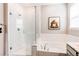 Elegant bathroom featuring a glass shower, soaking tub, and modern fixtures at 20936 E 61St Ave, Aurora, CO 80019