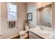 Well-lit bathroom featuring a vanity, framed mirror, toilet, and decorative art for modern living at 20936 E 61St Ave, Aurora, CO 80019