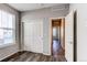 Bedroom featuring neutral colors, wood-look floors and double closets, leading to the main hallway at 20936 E 61St Ave, Aurora, CO 80019