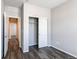 Neutral bedroom with sliding closet doors and wood-look floors, featuring light and airy aesthetic at 20936 E 61St Ave, Aurora, CO 80019