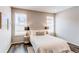 Relaxing bedroom featuring a comfortable bed, wood floors, and bright windows at 20936 E 61St Ave, Aurora, CO 80019