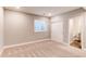 Comfortable bedroom featuring soft carpet, a window, a closet, and an ensuite bathroom at 20936 E 61St Ave, Aurora, CO 80019