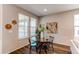 Cozy dining area with a round glass table and a view through the large windows at 20936 E 61St Ave, Aurora, CO 80019
