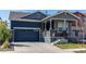 This two-story home has a two-car garage and welcoming covered front porch at 20936 E 61St Ave, Aurora, CO 80019