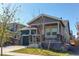 Inviting two-story home featuring a cozy covered porch, a well-kept lawn, and a two-car garage at 20936 E 61St Ave, Aurora, CO 80019