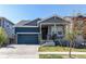 Charming two-story home with a covered porch, well-maintained lawn, and an attached two-car garage at 20936 E 61St Ave, Aurora, CO 80019