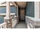 This home has a covered front porch with stone accents and light-colored siding at 20936 E 61St Ave, Aurora, CO 80019