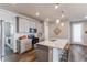 Modern kitchen with stainless steel appliances, light gray cabinets, and a quartz-topped island at 20936 E 61St Ave, Aurora, CO 80019
