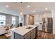 Open kitchen featuring stainless steel appliances and a large island overlooking the living area at 20936 E 61St Ave, Aurora, CO 80019