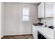 Bright laundry area with modern appliances, overhead cabinets and practical design for convenience at 20936 E 61St Ave, Aurora, CO 80019