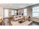 Bright living room with stylish furniture, a large area rug, and plenty of natural light at 20936 E 61St Ave, Aurora, CO 80019