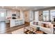Open-concept living space with modern finishes, hardwood floors, and a kitchen island with seating at 20936 E 61St Ave, Aurora, CO 80019