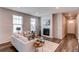 Inviting living room featuring a fireplace with a marble surround and light-filled windows at 20936 E 61St Ave, Aurora, CO 80019