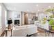 Open concept living room flowing into the kitchen, featuring a fireplace and modern lighting at 20936 E 61St Ave, Aurora, CO 80019