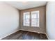 Bright office space featuring wood-look floors and large windows that offer plenty of natural light and backyard views at 20936 E 61St Ave, Aurora, CO 80019