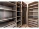 Spacious walk-in closet with custom shelving and drawers for optimal organization and storage solutions at 20936 E 61St Ave, Aurora, CO 80019