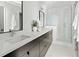 Modern bathroom with double vanity and glass shower at 1682 Tabor St, Lakewood, CO 80215