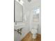 Clean and modern bathroom with floating vanity and hardwood floor at 1682 Tabor St, Lakewood, CO 80215