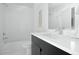 Modern bathroom with a white subway tile shower and bathtub at 1682 Tabor St, Lakewood, CO 80215
