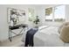 Main bedroom with large windows and a black accent table at 1682 Tabor St, Lakewood, CO 80215