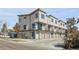 Modern townhomes with attached garages, balconies, and contemporary design stand out against a blue sky at 1682 Tabor St, Lakewood, CO 80215