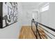 Bright hallway with hardwood floors and modern art at 1682 Tabor St, Lakewood, CO 80215