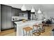 Modern kitchen island with white quartz countertops and dark cabinetry at 1682 Tabor St, Lakewood, CO 80215