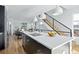 Modern kitchen island with white quartz countertops and dark cabinetry at 1682 Tabor St, Lakewood, CO 80215