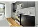 Modern kitchen with dark cabinetry and stainless steel appliances at 1682 Tabor St, Lakewood, CO 80215