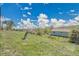 Expansive backyard with gentle slopes, lush greenery, and a charming single-story home in the background at 15805 W 14Th Pl, Golden, CO 80401