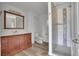 Well-lit bathroom with a vanity, toilet, and tiled shower with glass doors at 15805 W 14Th Pl, Golden, CO 80401
