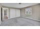 Carpeted bedroom with large windows, white trim, and double door closets at 15805 W 14Th Pl, Golden, CO 80401