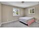 Neutral bedroom with carpet floors and plenty of natural light from two windows at 15805 W 14Th Pl, Golden, CO 80401