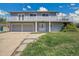 Two-story home featuring a balcony, three-car garage, and well-maintained lawn at 15805 W 14Th Pl, Golden, CO 80401