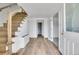 Bright foyer with hardwood floors and open staircase, leading to the living spaces at 15805 W 14Th Pl, Golden, CO 80401