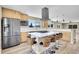 Modern kitchen features stainless appliances, a spacious island with seating, and scenic outdoor views at 15805 W 14Th Pl, Golden, CO 80401