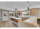 Modern kitchen showcases an island with seating, stainless appliances, light wood cabinets, and scenic views at 15805 W 14Th Pl, Golden, CO 80401