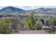 Scenic vista of mountains and buildings through verdant trees captures the beauty of the surrounding landscape at 15805 W 14Th Pl, Golden, CO 80401